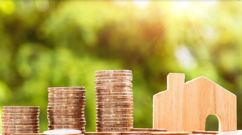 coins and a miniature house